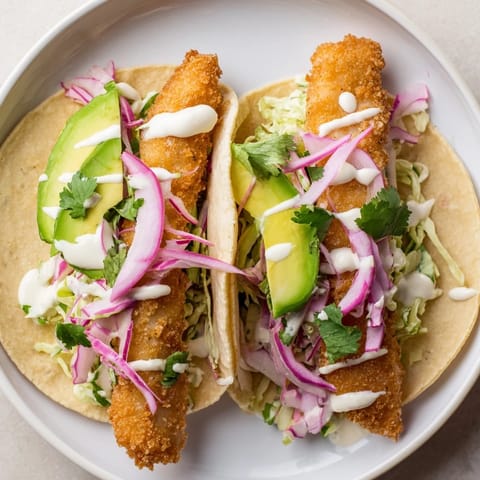 These Baja fish tacos show off crispy fish and colorful toppings ready to be devoured.