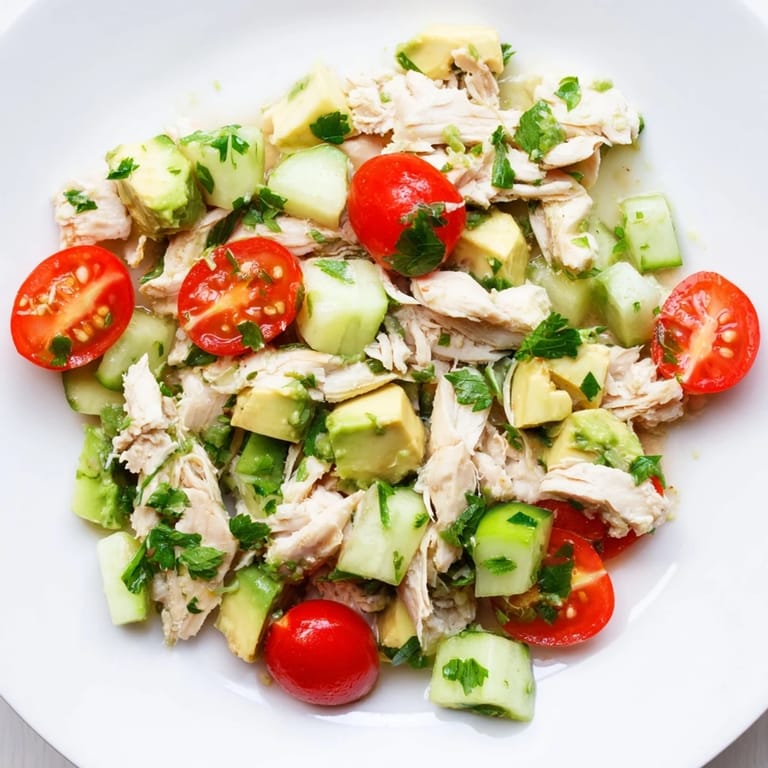 Healthy avocado chicken salad tossed with red onion and herbs, ideal for gluten-free, low-carb meal prep.