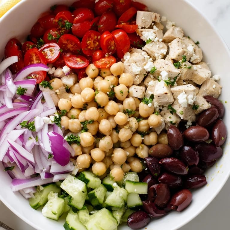 Vibrant Mediterranean Chickpea Chicken Salad in a rustic setting, ready to eat and garnished with fresh parsley and a squeeze of lemon.