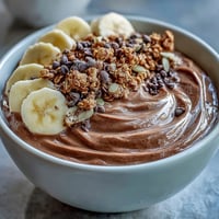 Thick and creamy Chunky Monkey smoothie bowl brimming with peanut butter and chocolatey flavor.
